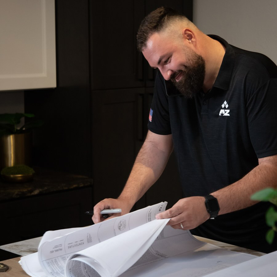 AZ Builder Solutions owner reviewing project blueprints